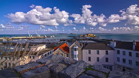 evening timelapse view over a small town beside the port in guernsey island in the english channel off the coast of normandy, part of the bailiwick of guernsey