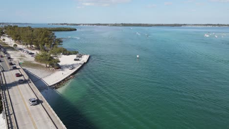 aerial zooming over longboat pass bridge, looking toward cortez from longboat pass in sarasota, florida