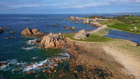 Le Gouffre de Plougrescant, rocky coastline, rugged granite cliffs, Brittany, France. Aerial drone forward