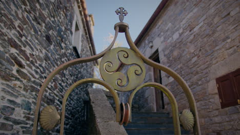 four legged triskel decoration in a well in o cebreiro galicia with shells of st james slow motion