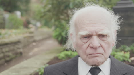 sad old man sitting on bench, medium close up