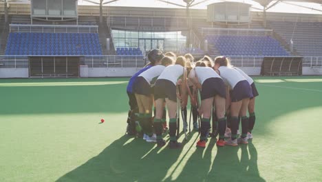 female hockey players preparing match on the field