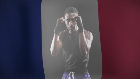 animation of flag of france over african american male boxer