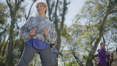 women practicing tai chi in a park
