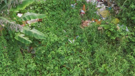 aerial shot of illegal trash pollution in lush philippine jungle