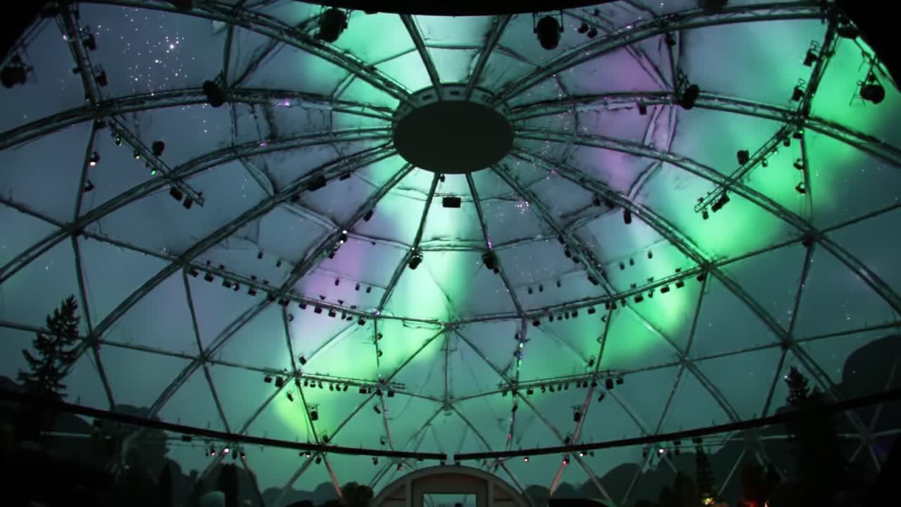 A Stunning Dome Structure Showcasing a Dramatic Light Display Above, Merging Nature and Architecture Under a Starry Sky with Artistic LED Illuminations