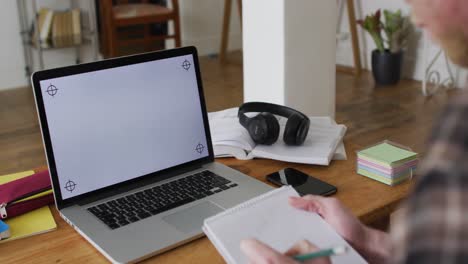 Albino-african-american-man-with-dreadlocks-working-and-using-laptop