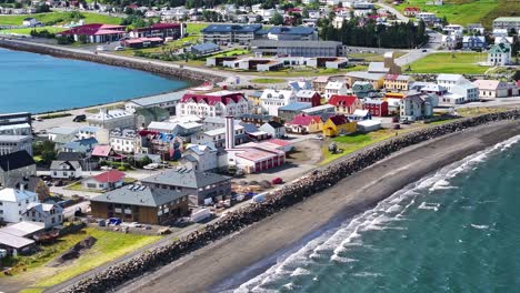 Aerial-View-of-Isafjordur,-Iceland-on-Sunny-Day,-Port-Town-Buildings-and-Sea-Waves