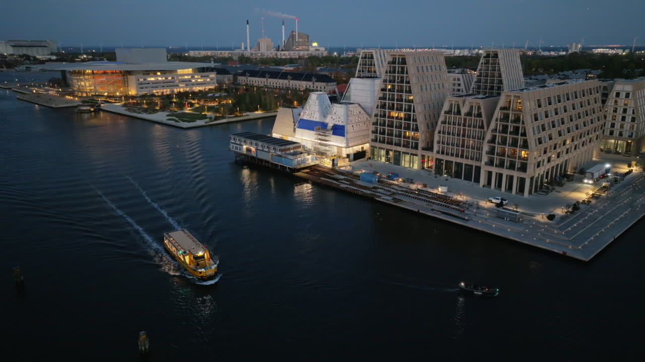 Aerial drone view of the Paper Island urban oasis surrounded by water in Copenhagen, Denmark at night