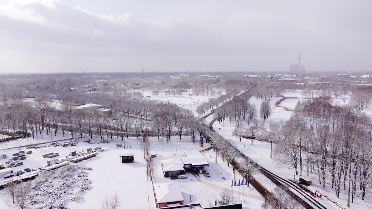 Bright sun breaks through heavy snowstorm over snowy Victory Park in Riga
