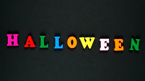 word halloween formed of wooden multicolored letters. colorful words loop. stop motion animation