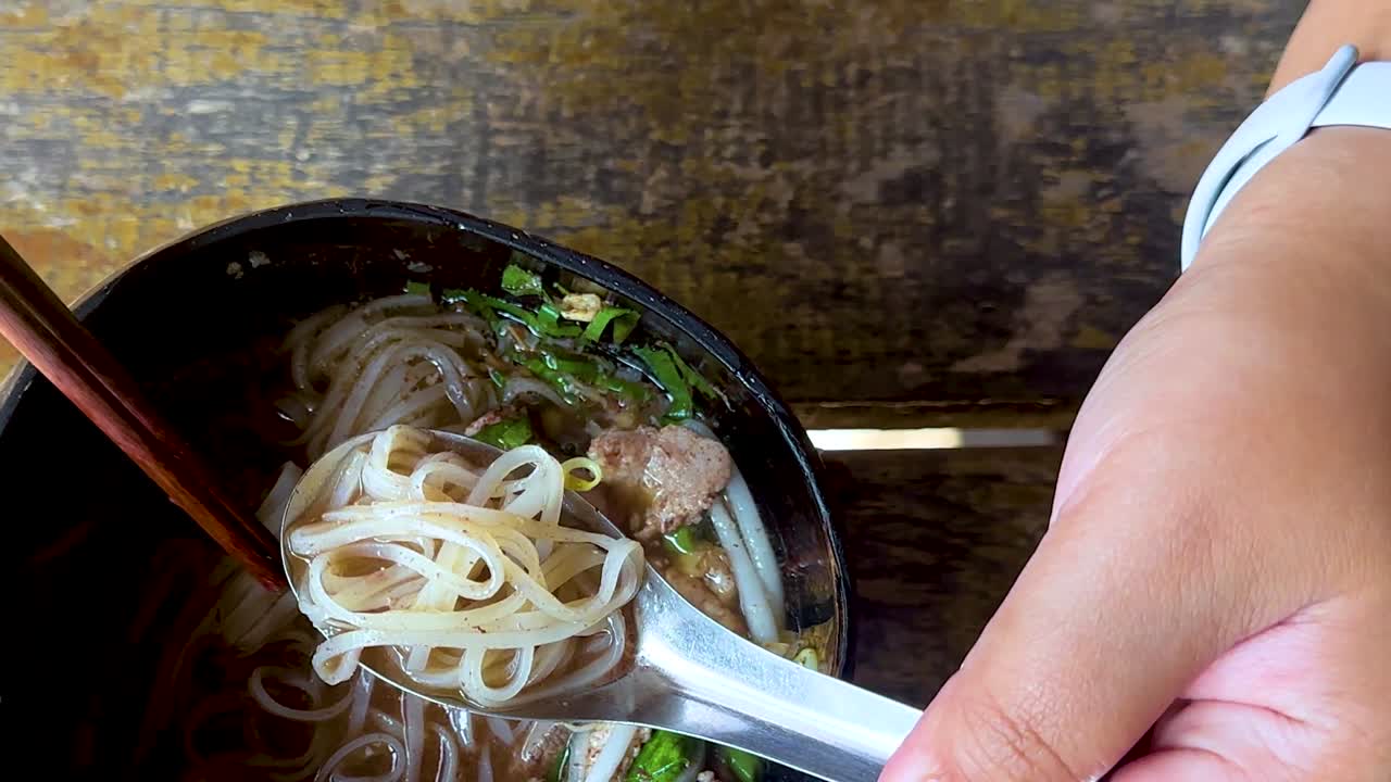 Eating Thai Noodle Soup