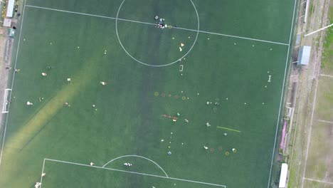 top down aerial view of a football training session in the buenos aires club at sunset