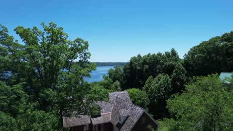 6 seconss of a reveal shot over a house ascending to lake monroe, in