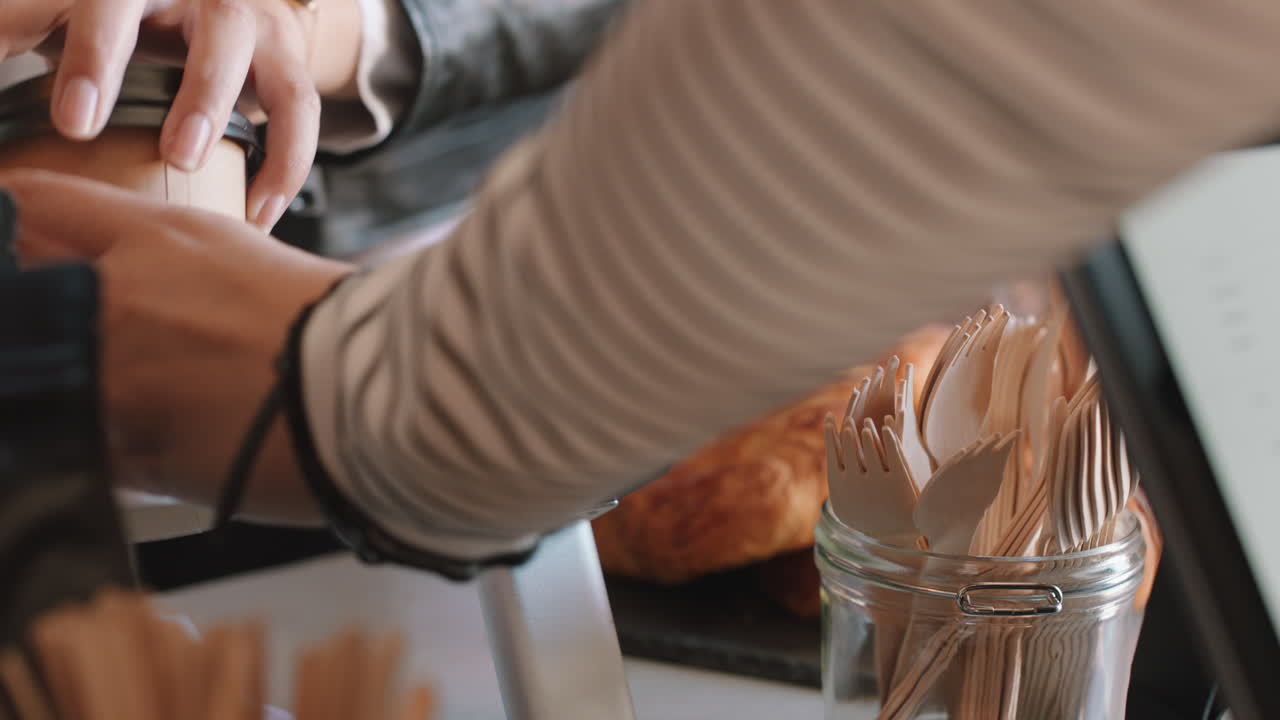 close up customer making contactless payment using smartphone mobile money transfer woman buying coffee in cafe enjoying service at restaurant