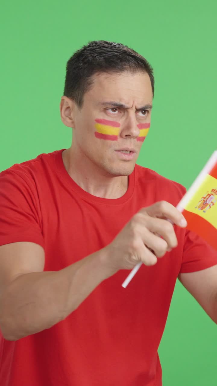 Nervous spanish supporter during an exciting match looking away