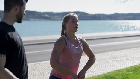 focused woman training with kettlebell at riverside