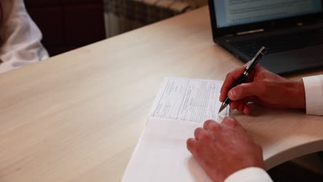 doctor signing medical form