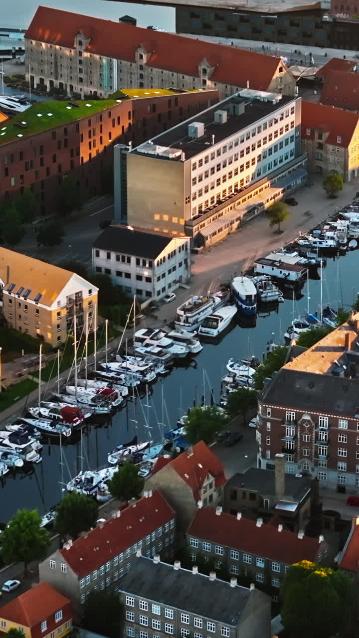 Aerial drone view of the city centre of the Copenhagen canals in Denmark at sunset. Vertical