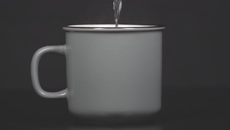 filling cup with hot water with vapour, slow motion 4k