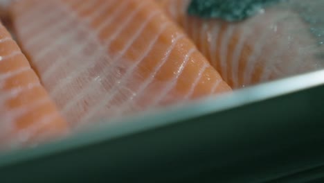 an up-close drop-down shot of raw fish, focusing on its fresh cuts, textures, and vibrant colors, perfect for showcasing fish preparation or seafood dishes.
