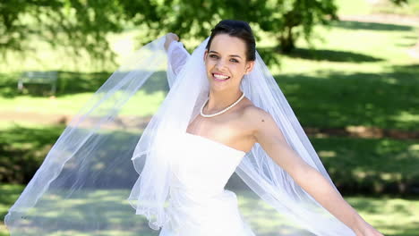 Beautiful-bride-smiling-at-camera-in-the-park