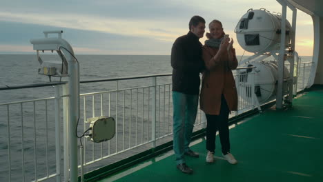 happy couple taking selfie on the ferry deck