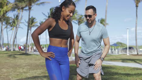 girl training with personal trainer in park