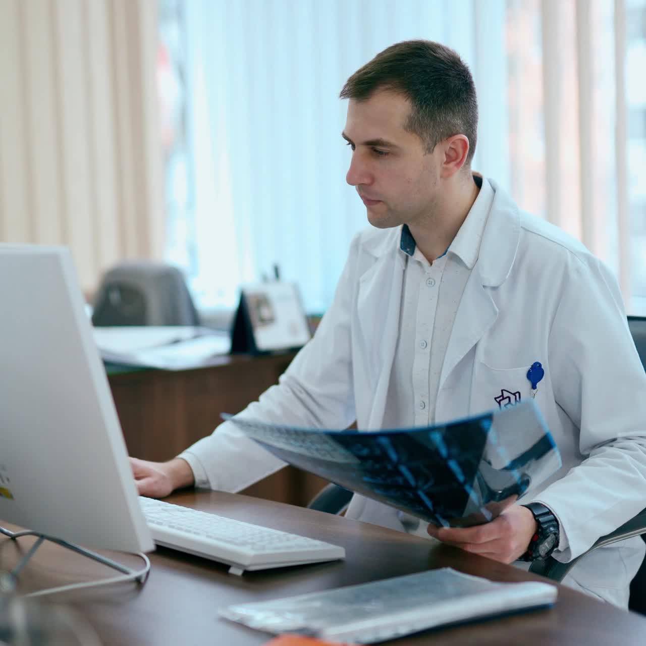 Male doctor holding x-ray