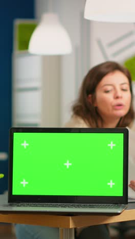 vertical video group of business people discussing company plan with mockup laptop