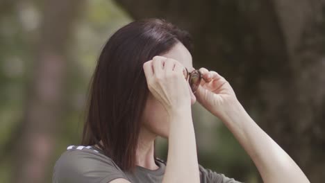 Slow motion, beautiful brunette, sunglasses, nature background