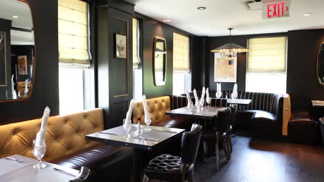 A-fine-dining-area-with-gold-and-black-chairs-and-tables