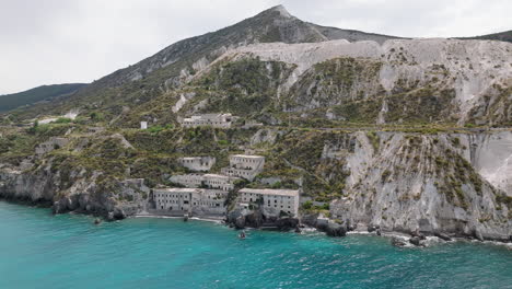 4K-Aerial-of-Lipari-Abandoned-Pomice-Mine-accomodation,-Italy