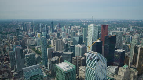 Toronto-City-From-Skyscraper-Viewing-Platform,-Wide-Tilt-Up-to-Horizon