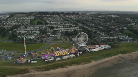 Aerial-4K-pan-of-amusement-park-beside-the-sea