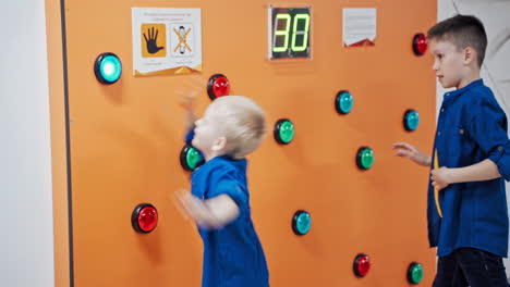 two boys play a game of reaction speed in scientific museum. science museum