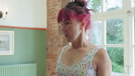 woman with pink hair in white dress