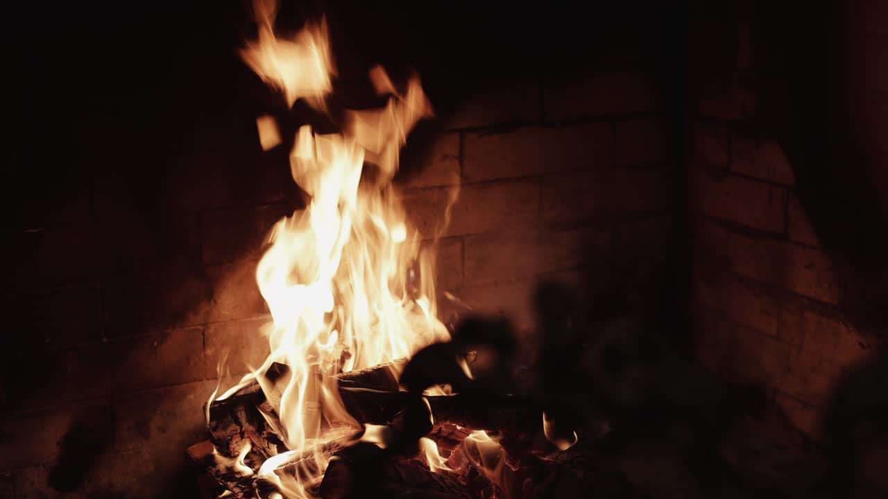 Close-up of a cozy fireplace with burning logs and bright flames