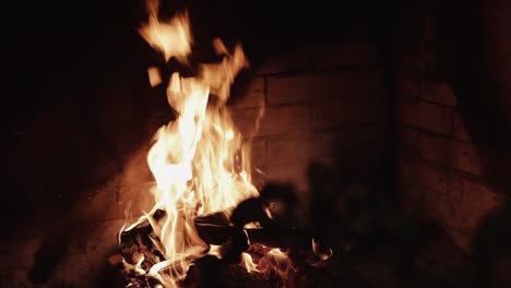 close-up of a cozy fireplace with burning logs and bright flames