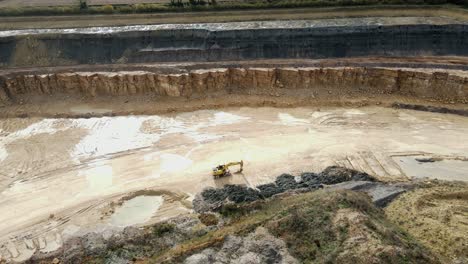 aerial view of an excavator in a large quarry