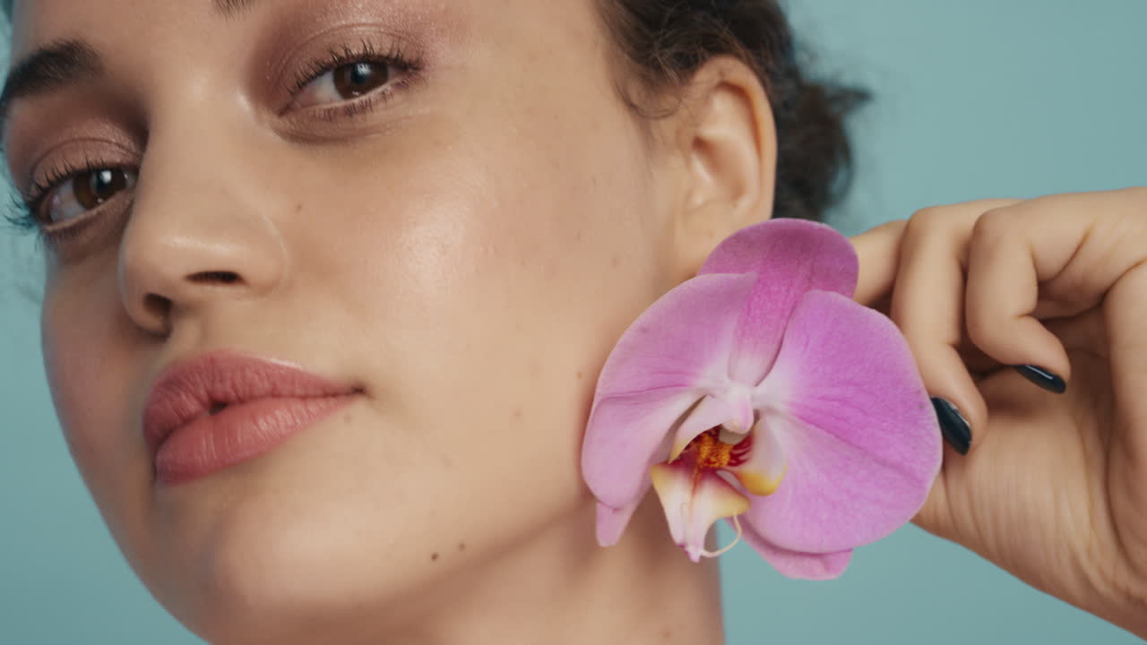 schönheitsporträt aus der nähe schöne frau körper berühren mit bunten rosa orchideenblumen streicheln glatte gesunde hautfarbe genießen frischen natürlichen duft hautpflege konzept