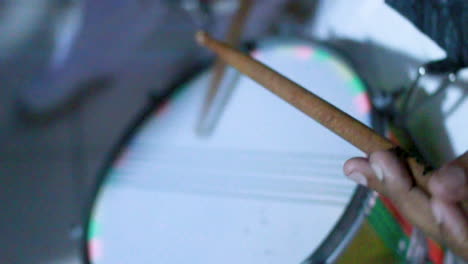 musician playing snare drum while woman dances in background