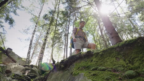 a man with a backpack behind him in a hike lower view angle