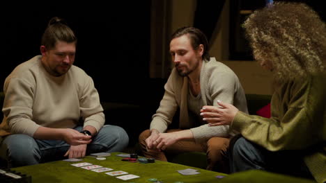 group of friends playing poker sitting on the couch in the living room 9