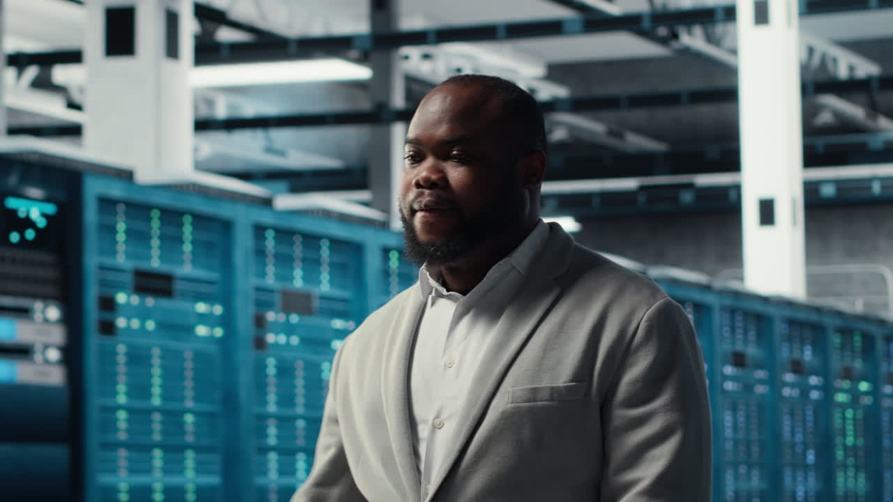 Vertical video Smiling employee walking in high tech data center