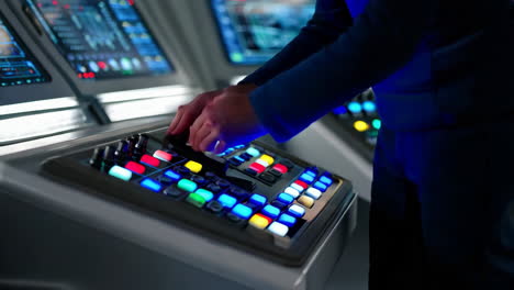 person operating a futuristic control panel