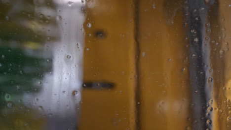 Inside-vehicle-view-of-car-wash-while-being-washed,-close-up-view