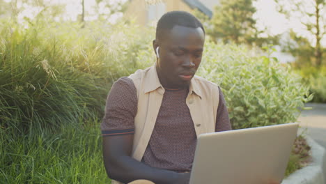 African-American-Freelancer-Working-on-Laptop-on-Street