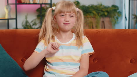 upset teen girl showing thumbs down dislike bad work disapproval dissatisfied feedback at home
