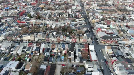 poverty stricken, low income housing, dense population inner city reading, pa, usa, school bus crosses intersection, aerial drone shot, tilt up revealing downtown business district in pennsylvania